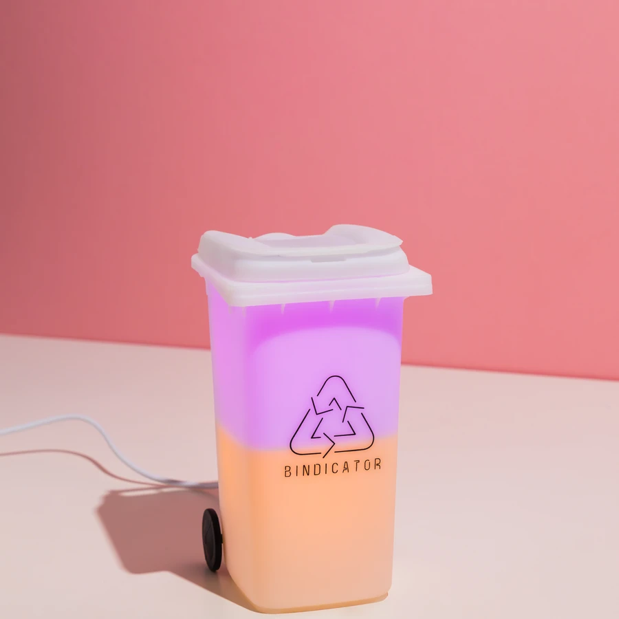 Bindicator lamp glowing in Canberra (ACT) bin colours on a kitchen shelf