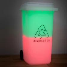 Bindicator lamp glowing in red and green bin colours the night before collection